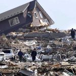 House split - People walk in the rubble in Minamisanriku town, Miyagi Prefecture
