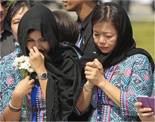 Malaysian Flight MH17 Victims Return Home - MAS crew members cry with sadness