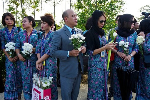 Malaysian Flight MH17 Victims Return Home - MAS staff holding flowers 2