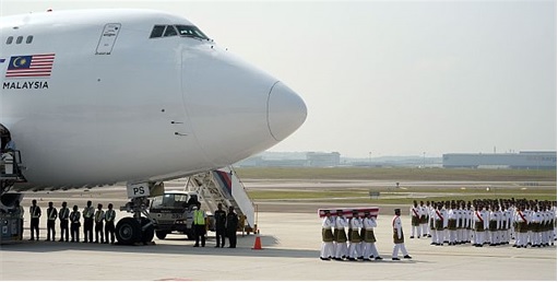 Malaysian Flight MH17 Victims Return Home - Soldiers Carrying Coffin from flight MH6129 - 1