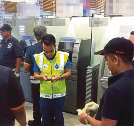 Malaysian ATM Hacked and Robbed - Police at ATM Scene
