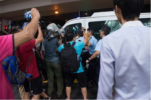 The journalists followed an accused triad member, who was protected by the Hong Kong police force.