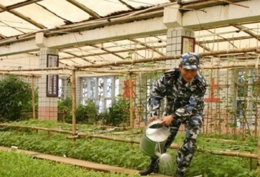 Fiery Cross Reef in South China Sea - Soldier Watering Plants