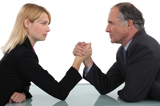 Older Worker and Young Worker - Arm Wrestling