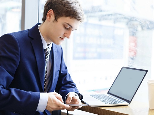 Young Worker Use Social Media - Smartphone - At Work in Office