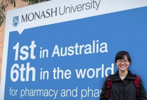 monash-university-student-standing-in-front-of-signboard