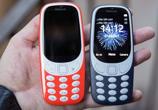 Holding Two New 2017 Release Nokia 3310 - Red and Grey Colour