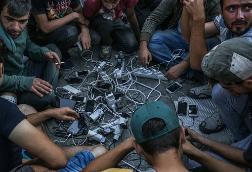 Refugees Recharging Cell Phone