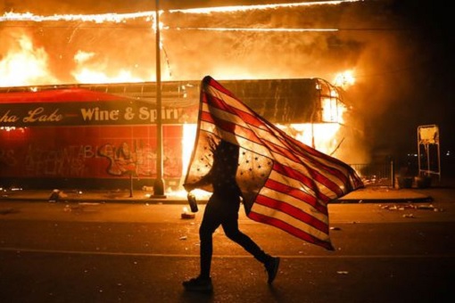 US Race Riots - Carrying American Flag While Buildings Burning