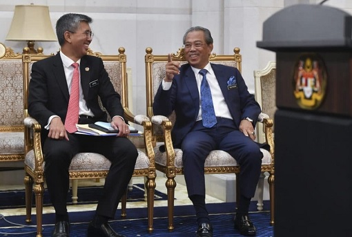Finance Minister Tengku Zafrul and Prime Minister Muhyiddin Yassin