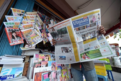Utusan Malaysia - Reading Newspaper at Store