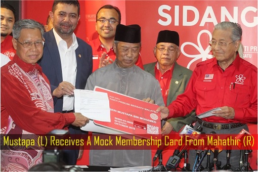 Mustapa Receives A Mock Membership Card From Mahathir